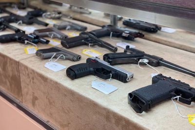 Tagged used handguns for sale on a display counter