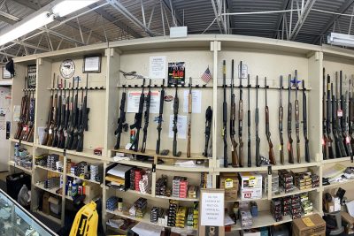Wall of new and used rifles and shotguns on display at BJ’s Pawn Shop