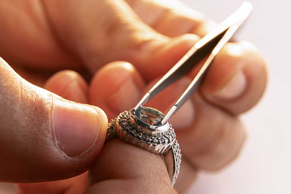 Jeweler repairing a ring with precision tools